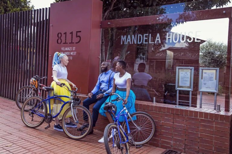 David Motsamayi: The Journey of Resilience Visitors with bicycles outside Mandela House at 8115 Vilakazi Street, Orlando West, Soweto