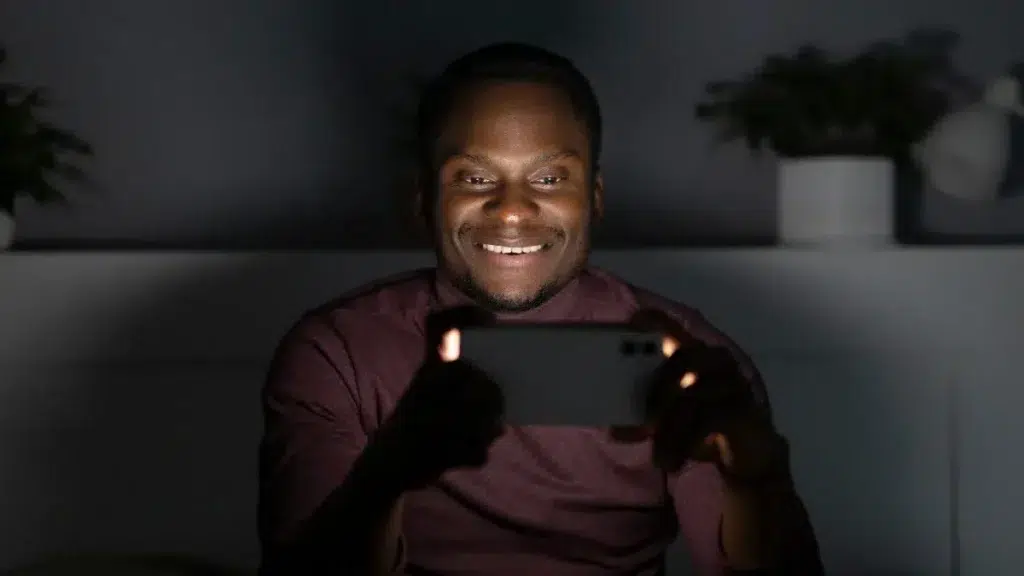 African american man watching streaming service indoors
