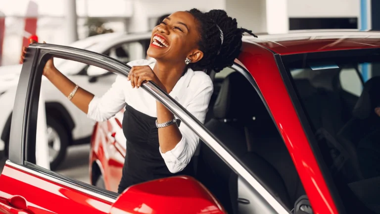 Stylish black woman in a car salon (1)