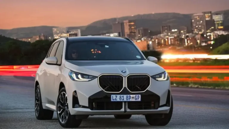 BMW X3 SUV parked in front of a modern building, celebrating Car of the Year 2025 win.