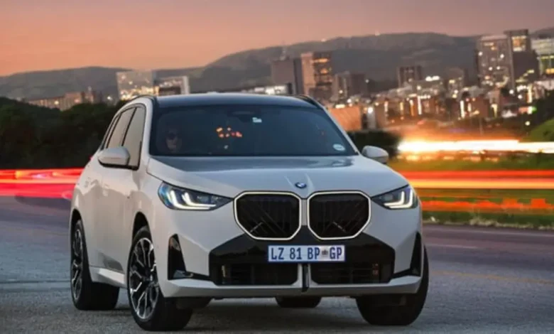 BMW X3 SUV parked in front of a modern building, celebrating Car of the Year 2025 win.
