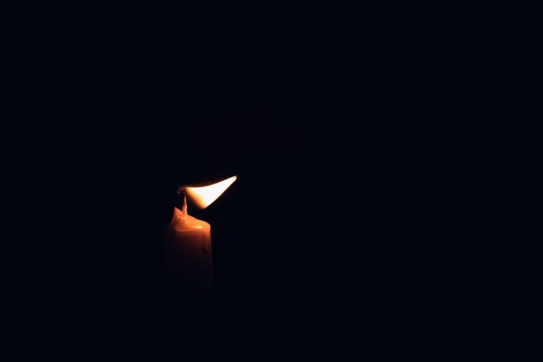 Mamelodi Hostage Situation Ends in Tragedy: SAPS Officer and Nephew Dead A single lit candle on a black background