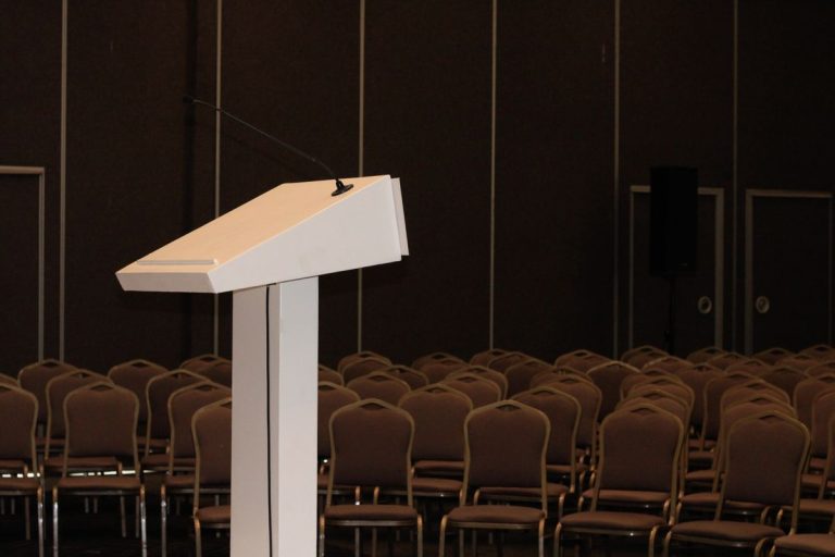 Tshwane Tourism Showcase 2026 Set to Unite the Capital’s Tourism Industry in a Free One-Day Event Empty white podium with a microphone in front of rows of chairs