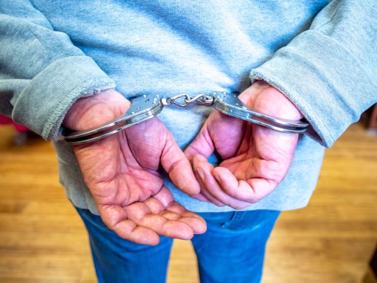 Handcuffed hands behind a person's back