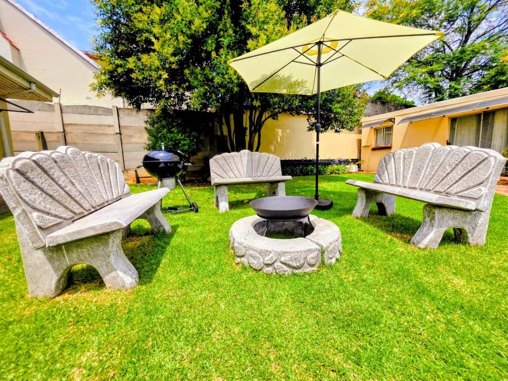 Garden seating, fire pit and braai at Tau Golden Mane Guest House
